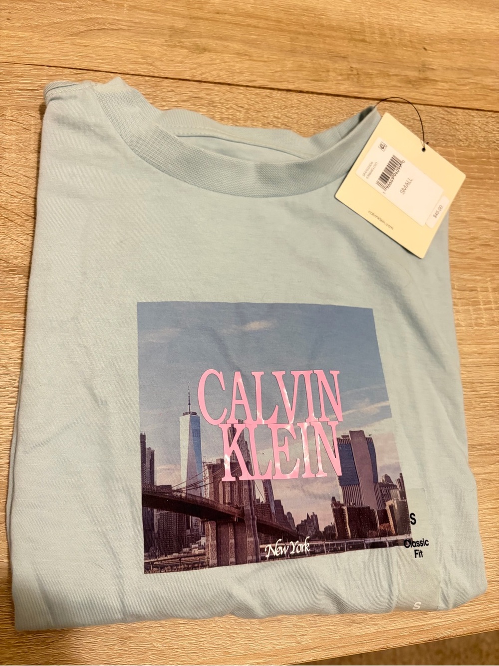 Calvin Klein Light Blue Graphic Tee with Pink Logo